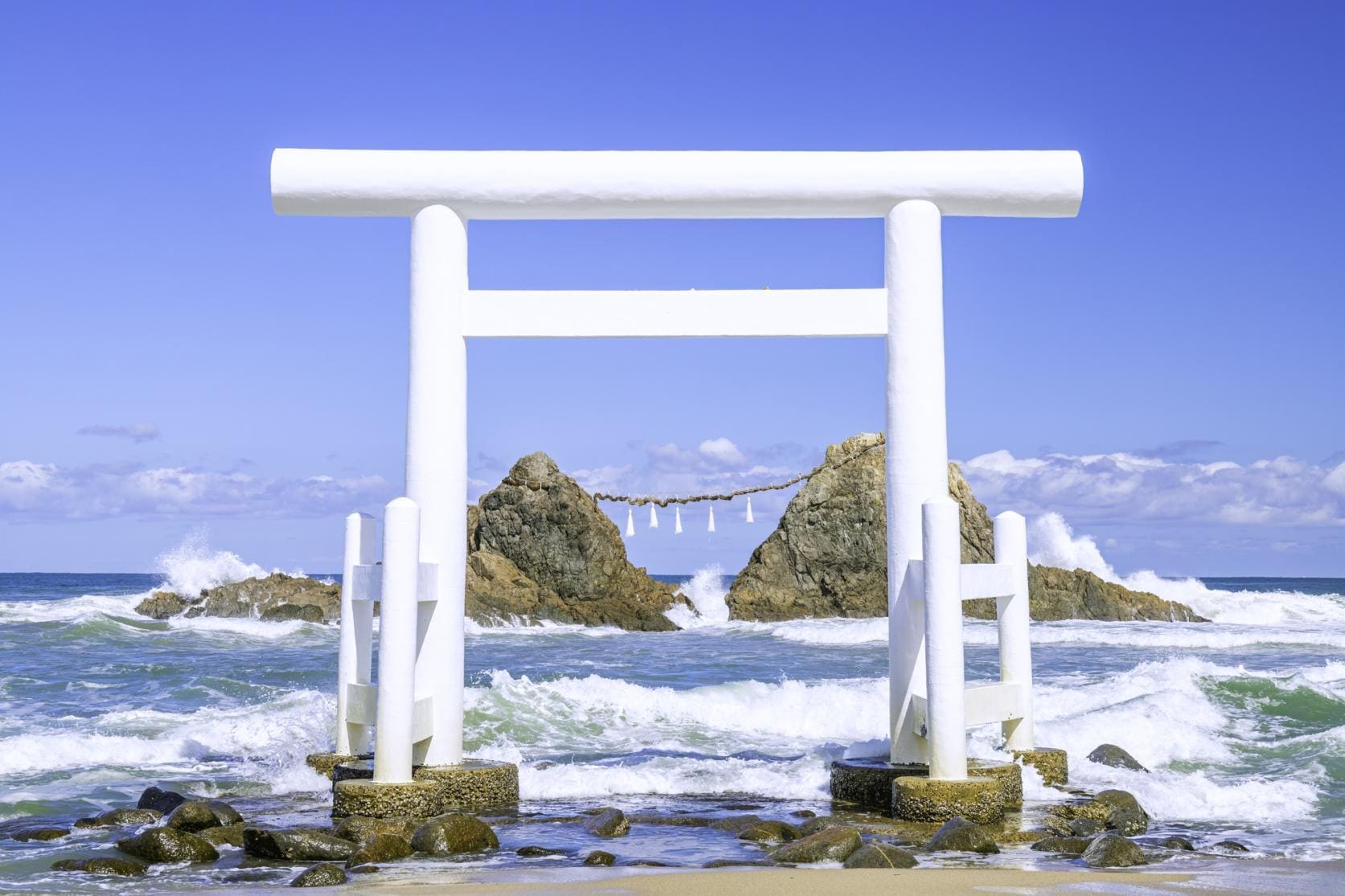 Scenic ocean view of Itoshima floating torii gate with Meotoiwa couple rocks at sunset
