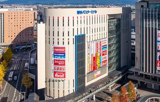 Hakata Bus Terminal entrance with teal facade, bus bound for Futamigaura