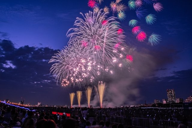 Riverside park at dusk during summer fireworks festival in Tokyo